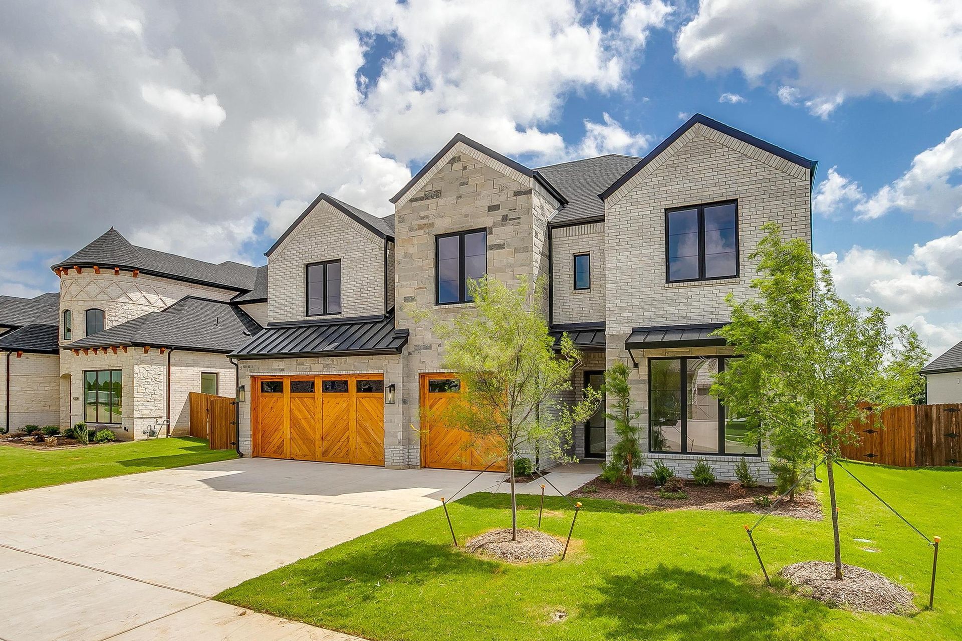 A large house with a lot of windows and a lot of grass in front of it.