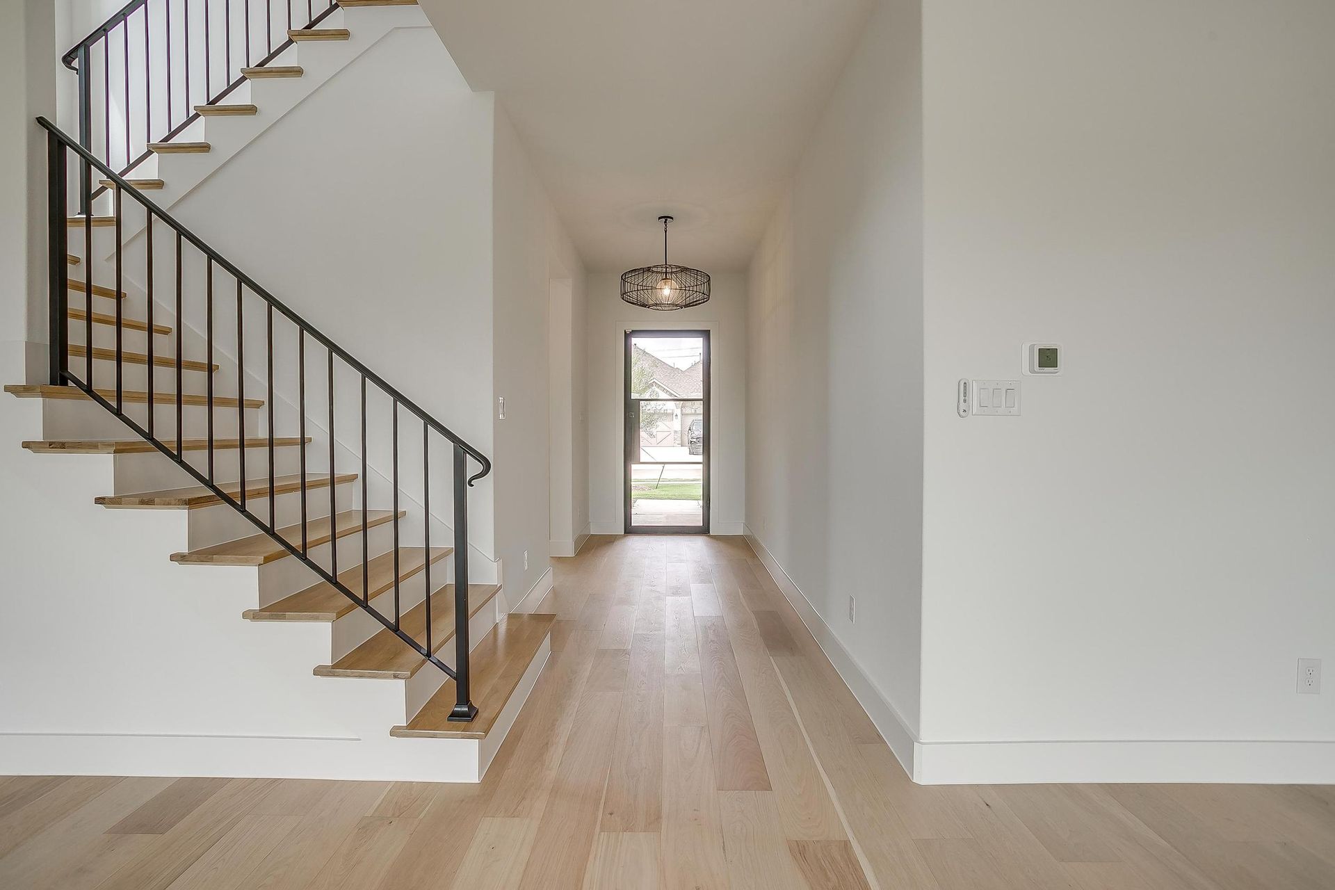 There is a staircase in the middle of the hallway.