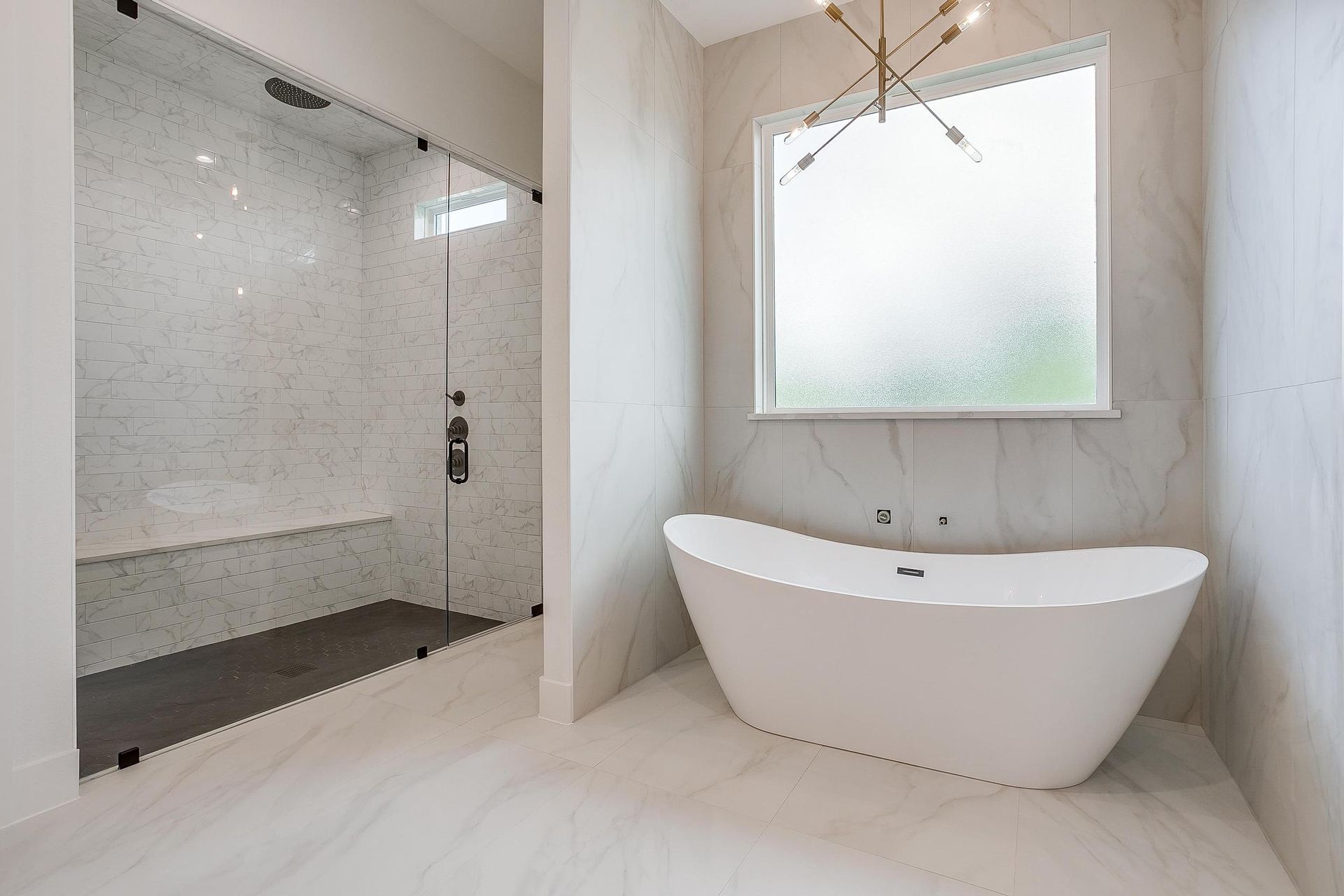 A bathroom with a tub , shower , and window.