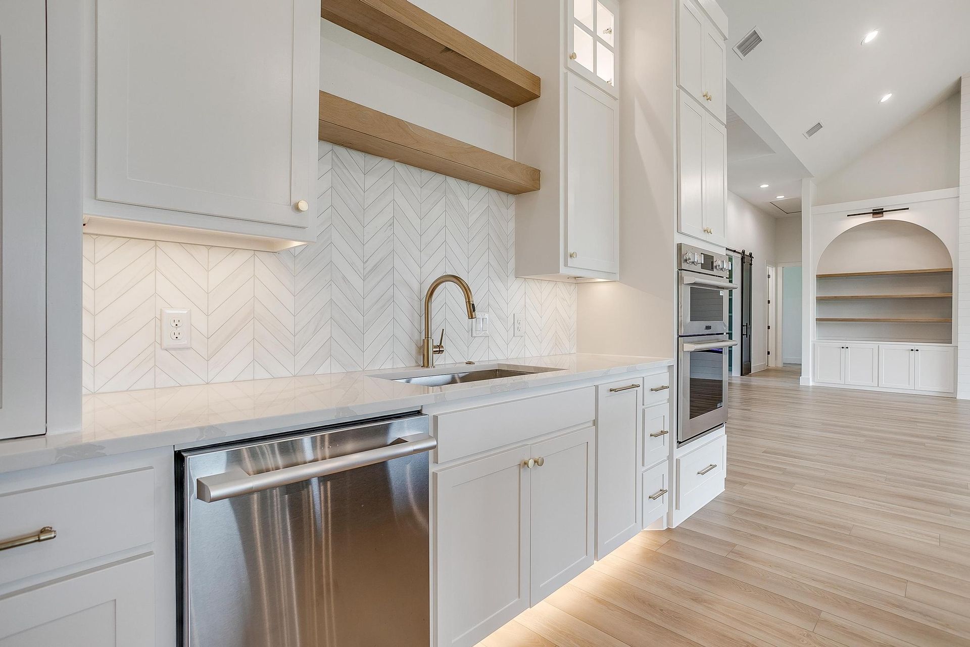 A kitchen with white cabinets and stainless steel appliances.