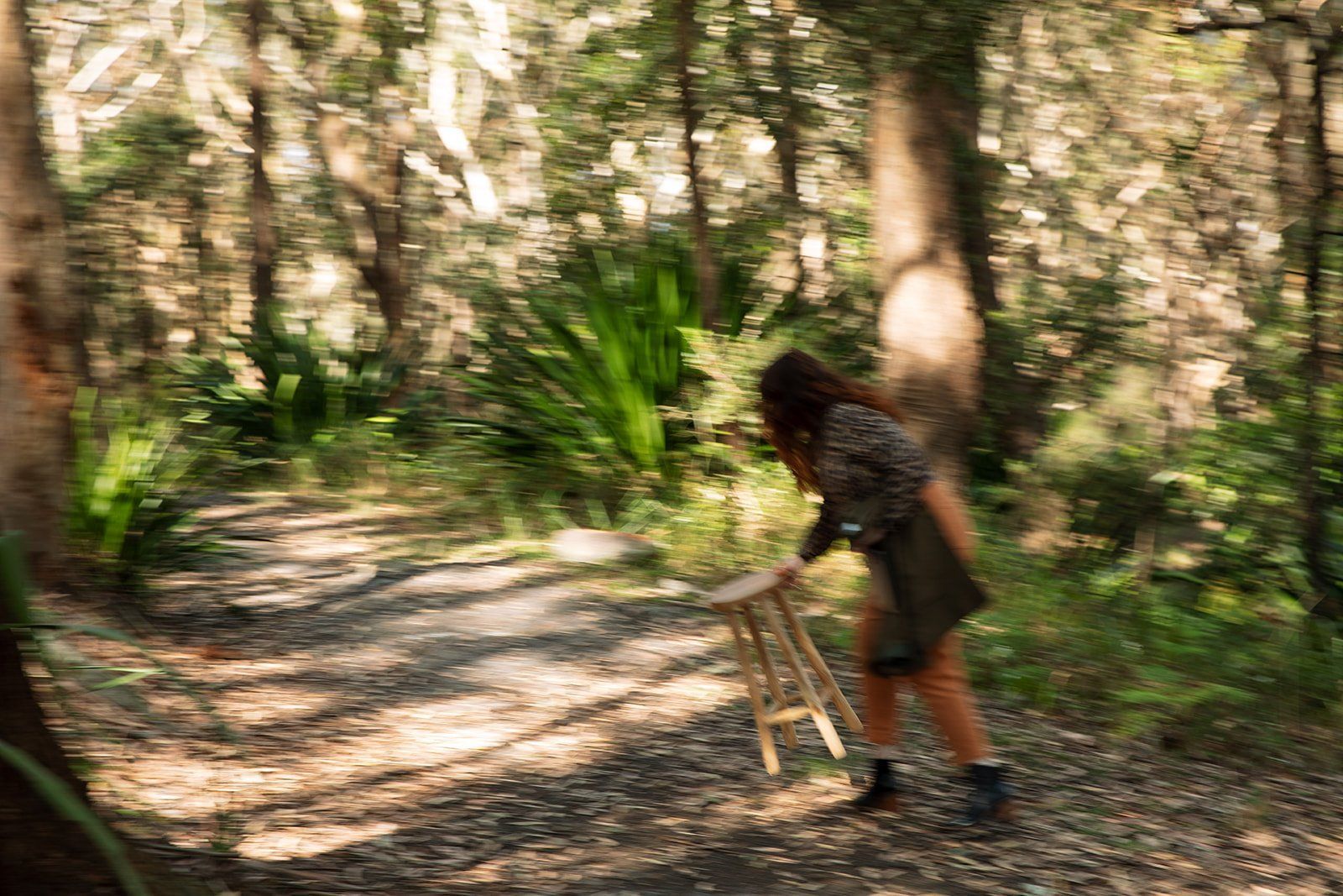Person In A Forest Setting Bending Over A Small Stool — Everyday Interiors in Helensburgh, NSW