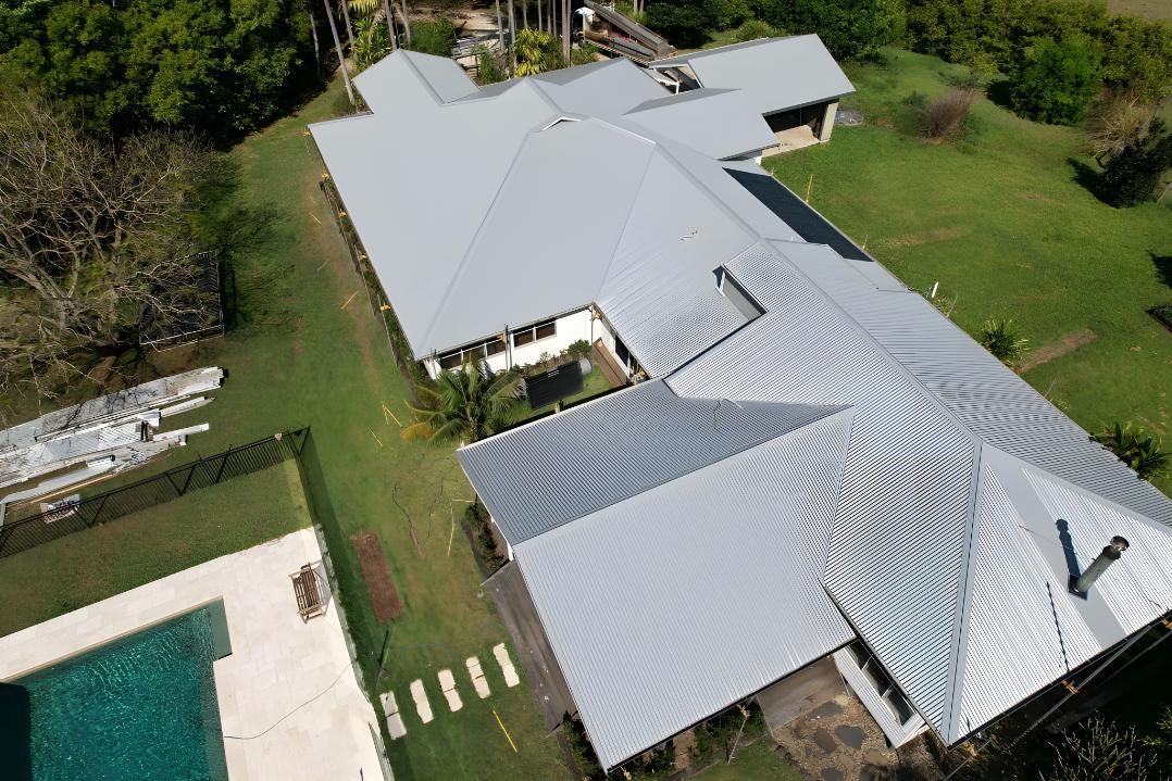 An Aerial View Of A Large House With A Swimming Pool — Premier Roofing Solutions In Kingscliff, NSW