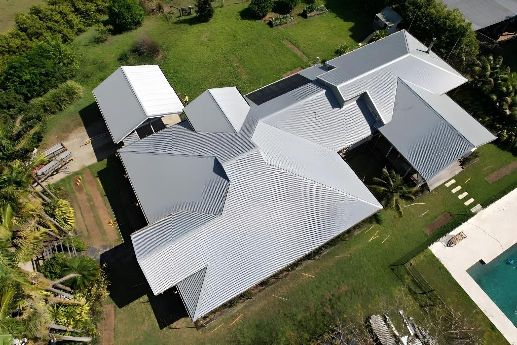 An Aerial View Of A Large House With A Swimming Pool — Premier Roofing Solutions In Lennox Head, NSW