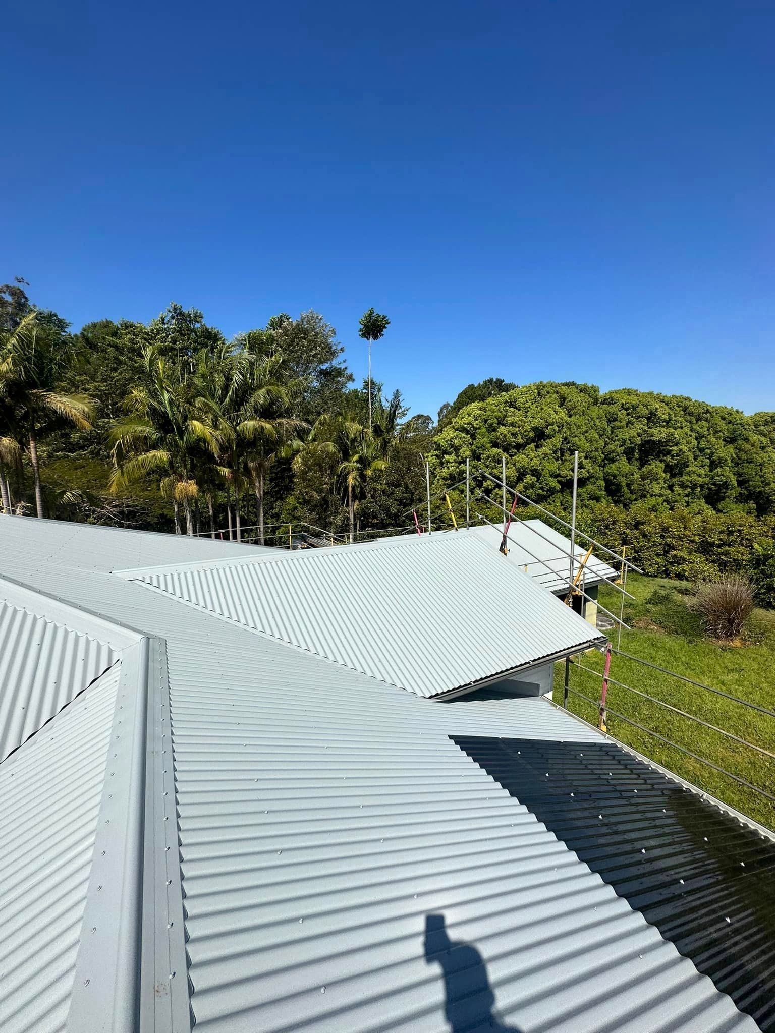 A Roof With A Blue Sky And Trees In The Background — Premier Roofing Solutions In Lennox Head, NSW