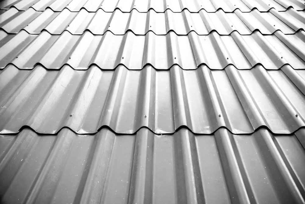 Close-up of a corrugated metal roof showing overlapping steel sheets and ridged profile.