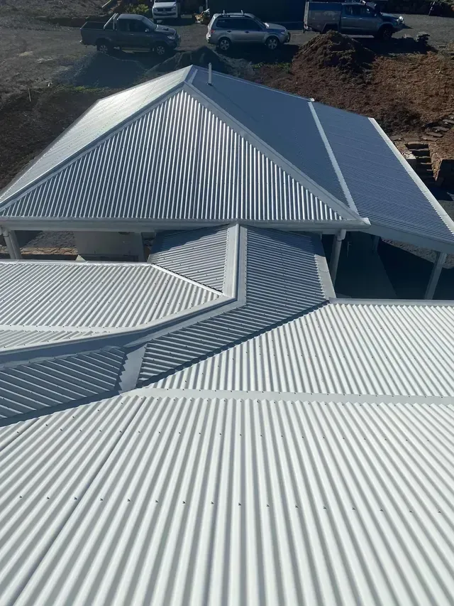 An Aerial View Of A White Corrugated Metal Roof On A House — Premier Roofing Solutions In Lennox Head, NSW