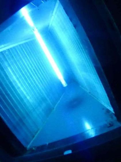 A Blue Light is Shining Through a Window in a Dark Room