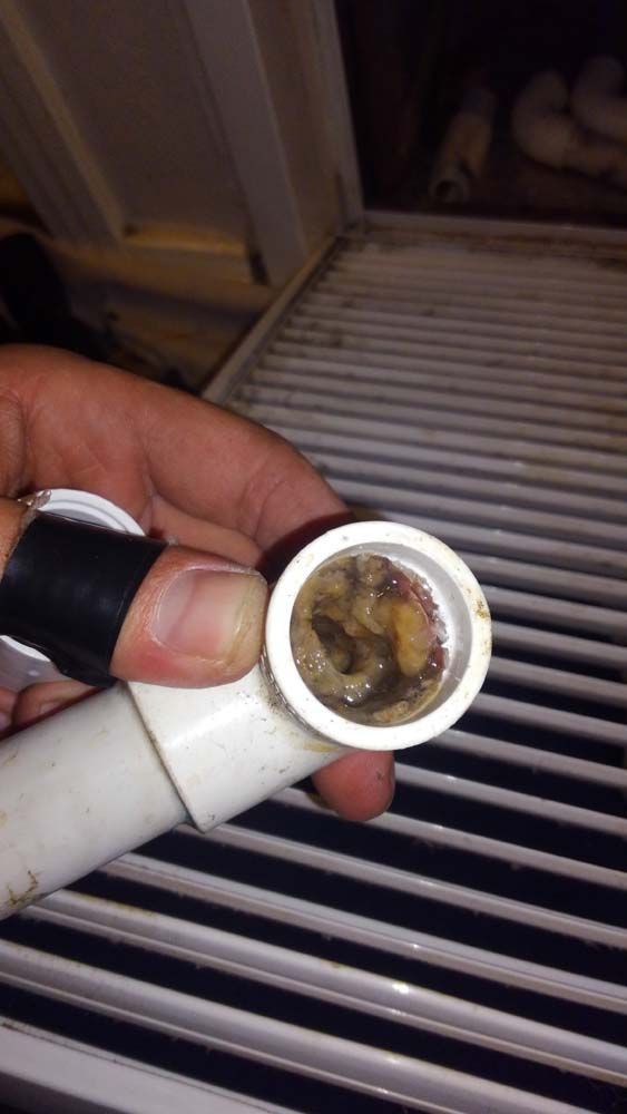 A person is holding a pipe with a hole in it.