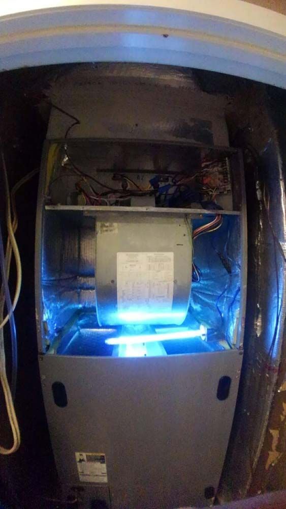 The inside of an air conditioner with a uv light on it.