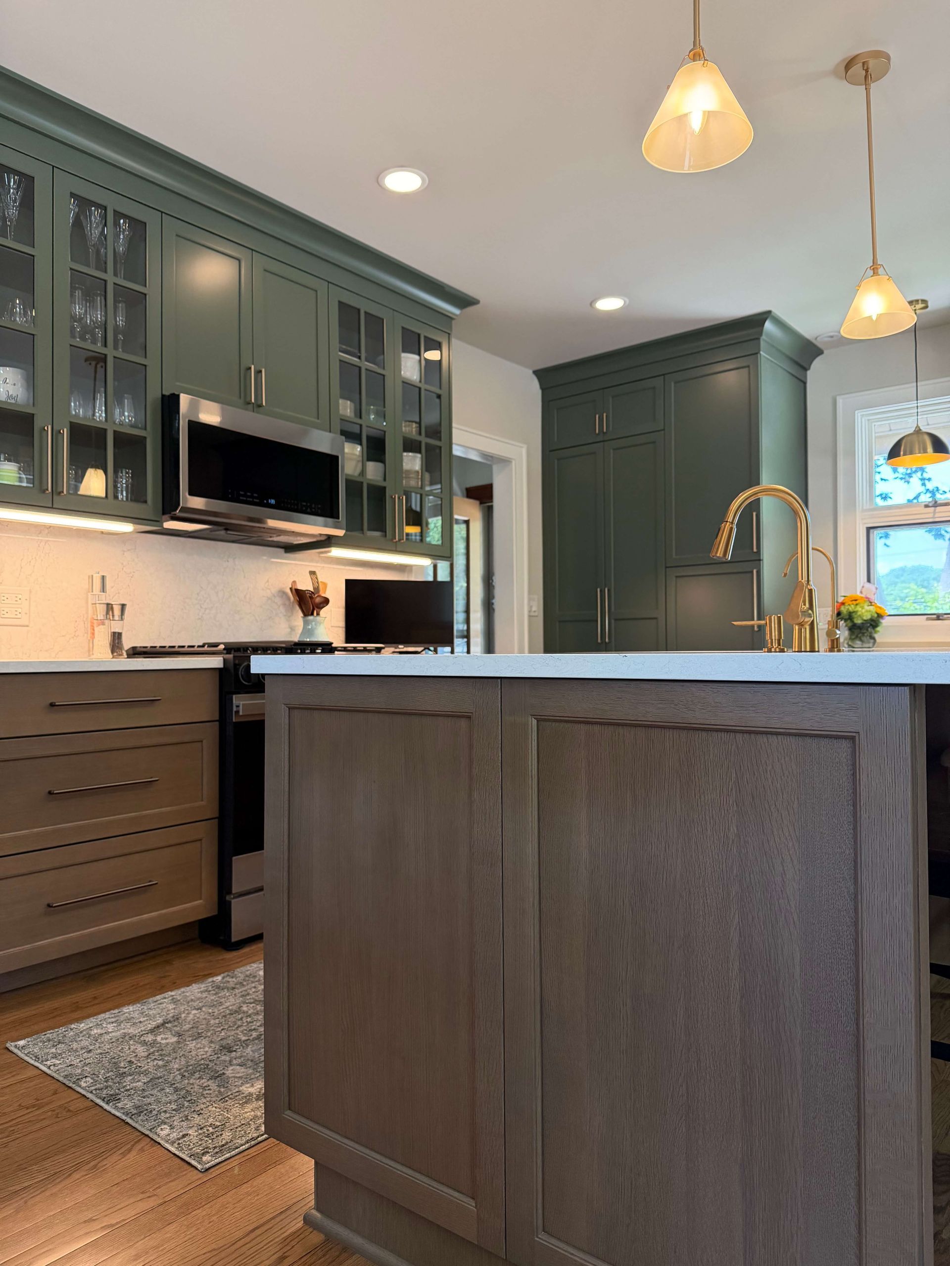 Kitchen remodeling in Glenview, IL, featuring a bright white hallway with wood floors, an arched doorway, and built-in cabinets leading to a room beyond.