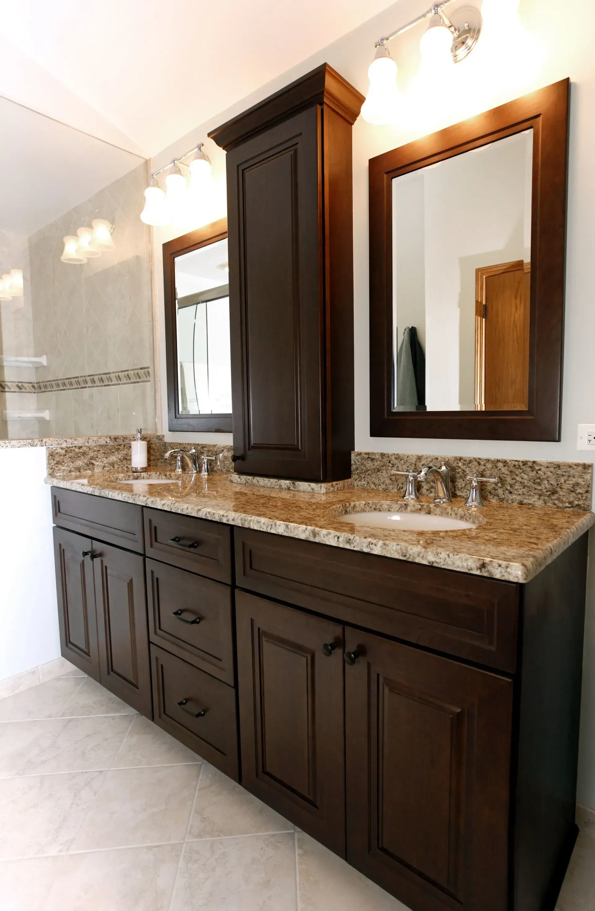 A bathroom with two sinks and two mirrors