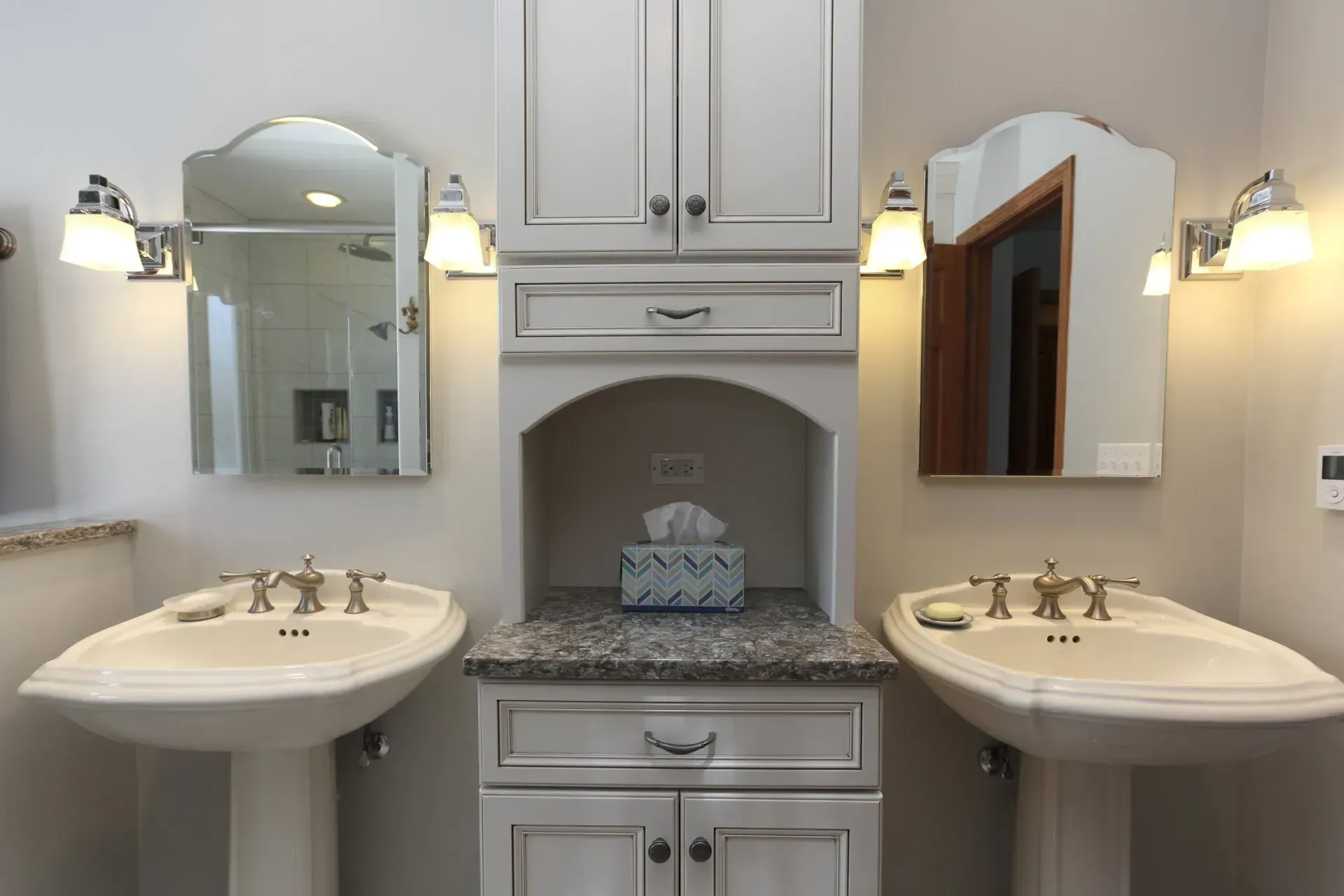 A bathroom with two sinks and two mirrors.