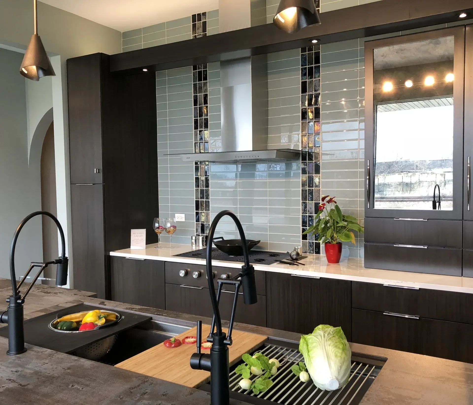 A kitchen with two sinks and a stove top oven