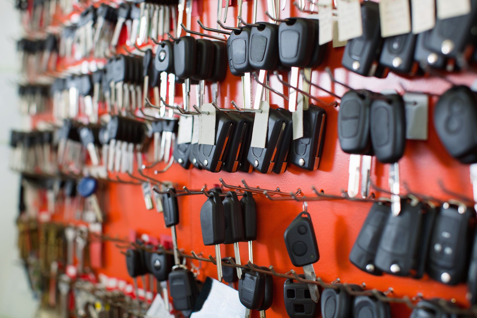 Wall display filled with assorted car keys and fobs.