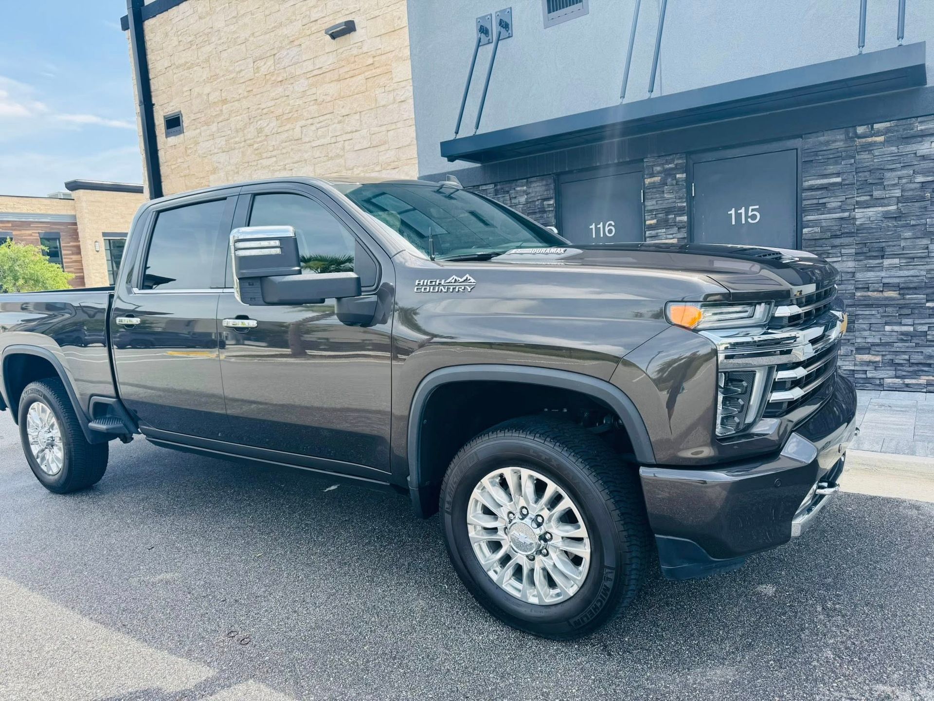 A pickup truck is parked in front of a building.