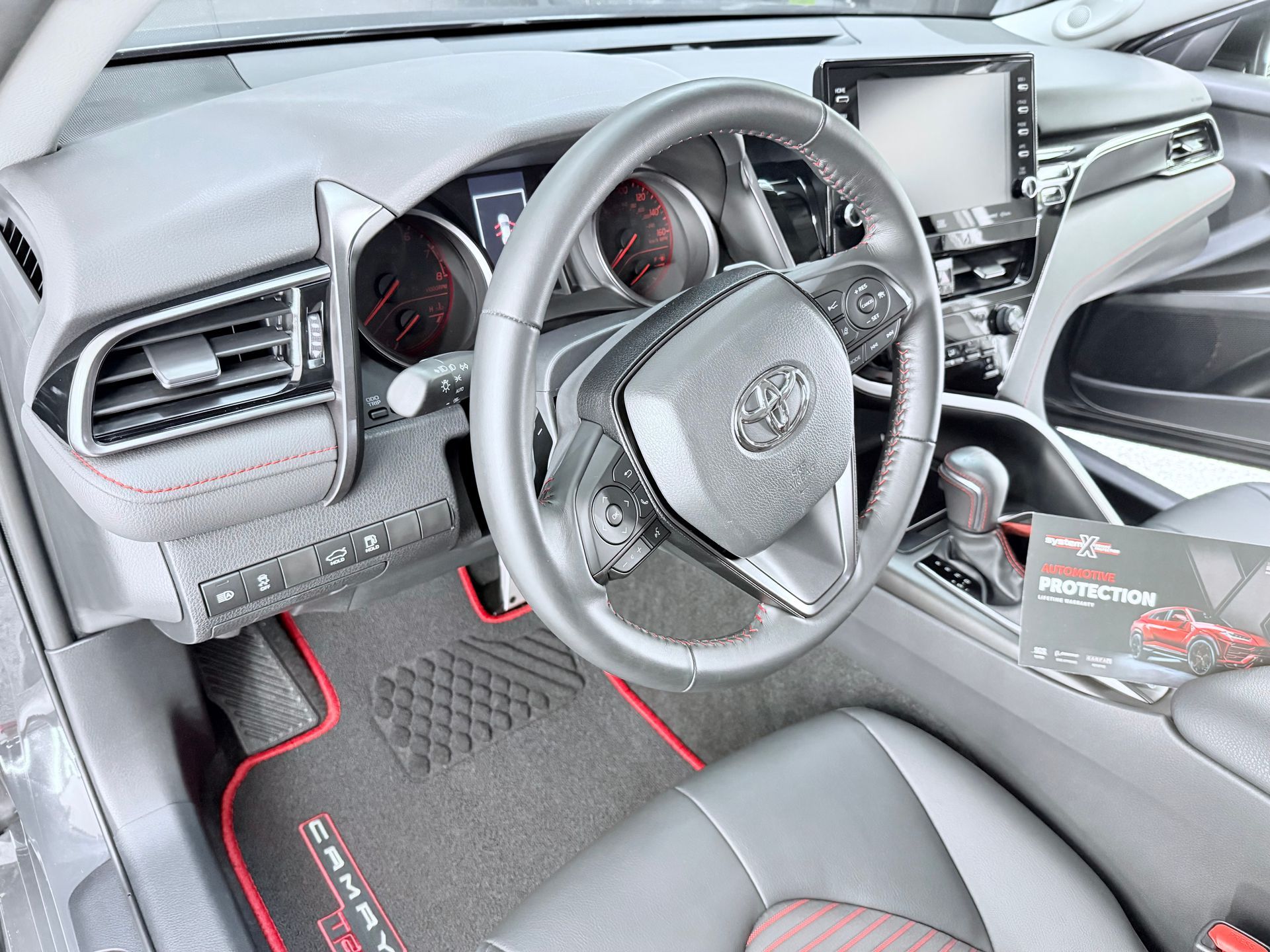 The inside of a car with a piece of paper on the steering wheel that says ' it makes a difference '