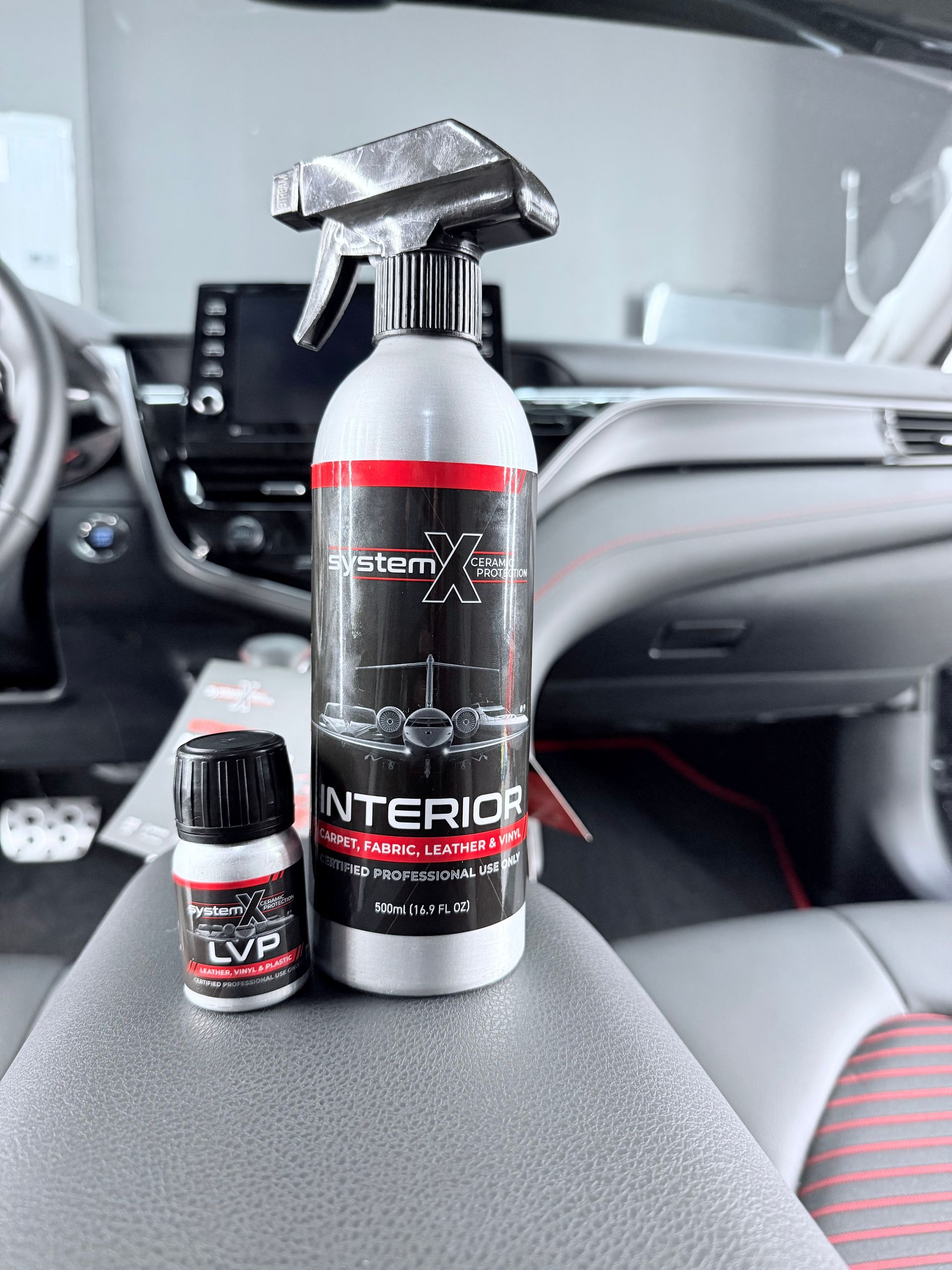 The interior of a tesla model s with white seats and a steering wheel.