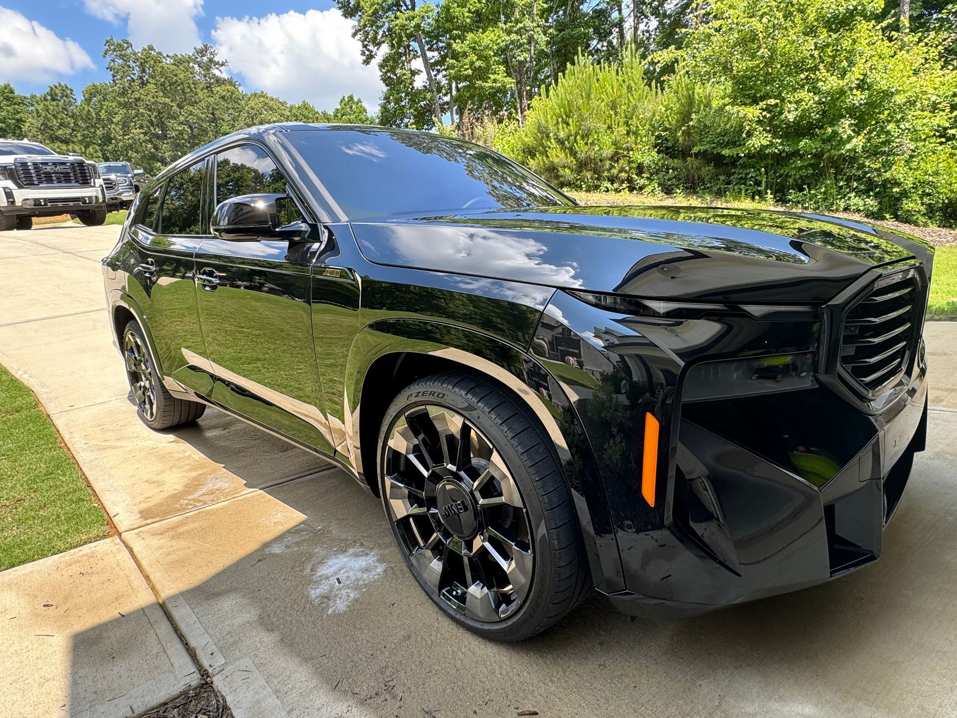 A blue nissan sentra is parked in a driveway.