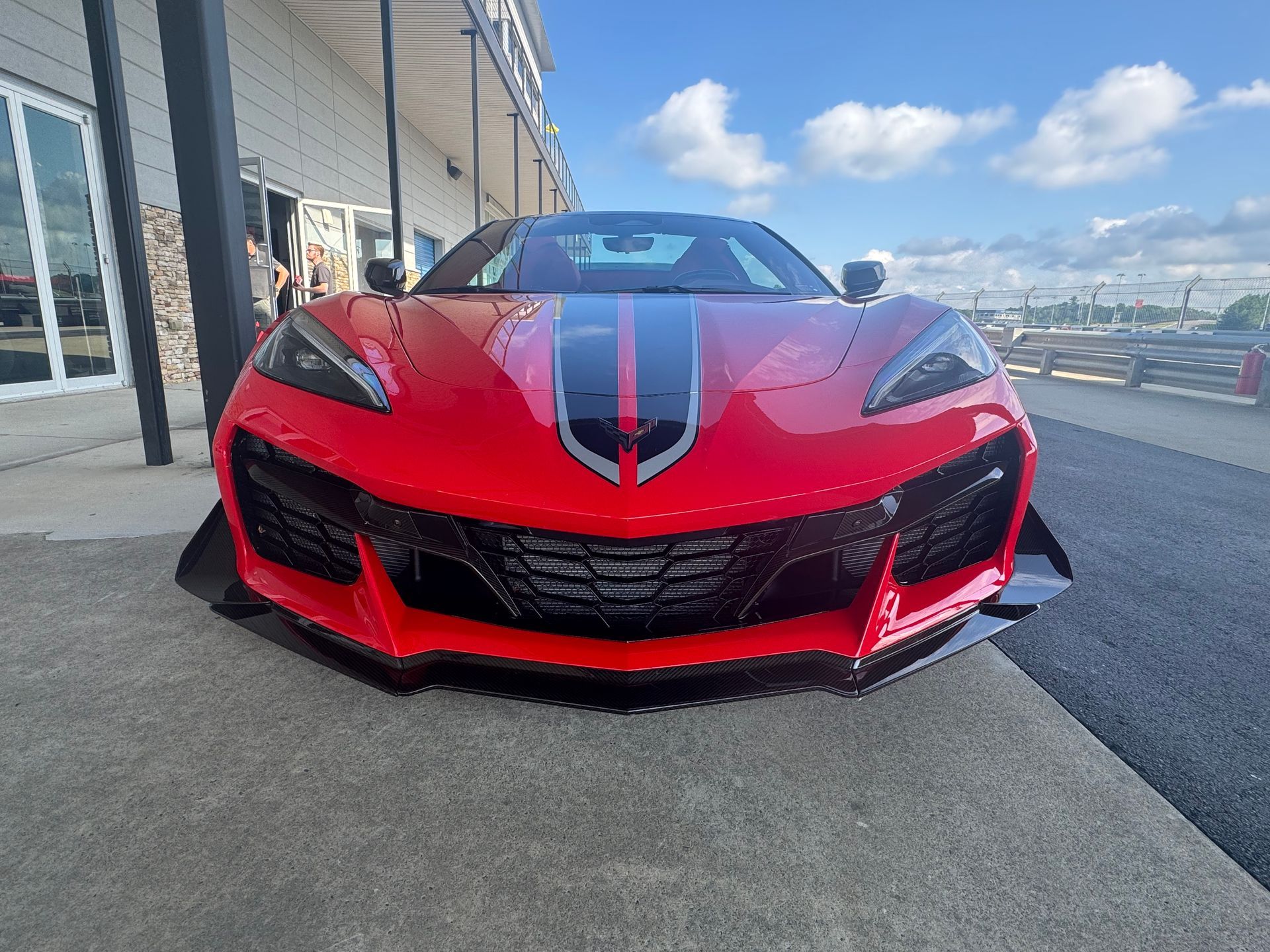 A black sports car is parked in a parking lot.