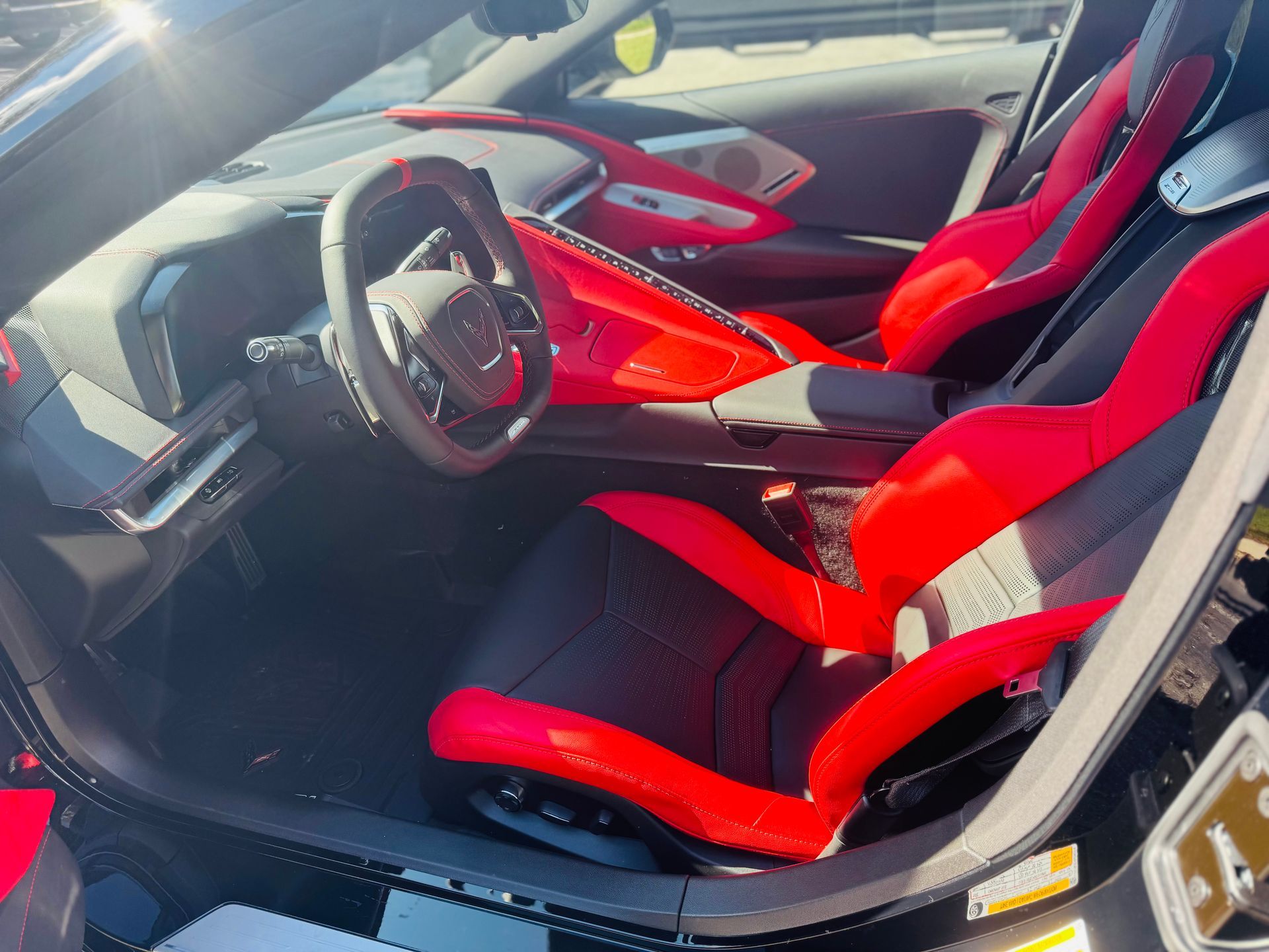 The trunk of a black car with orange seats