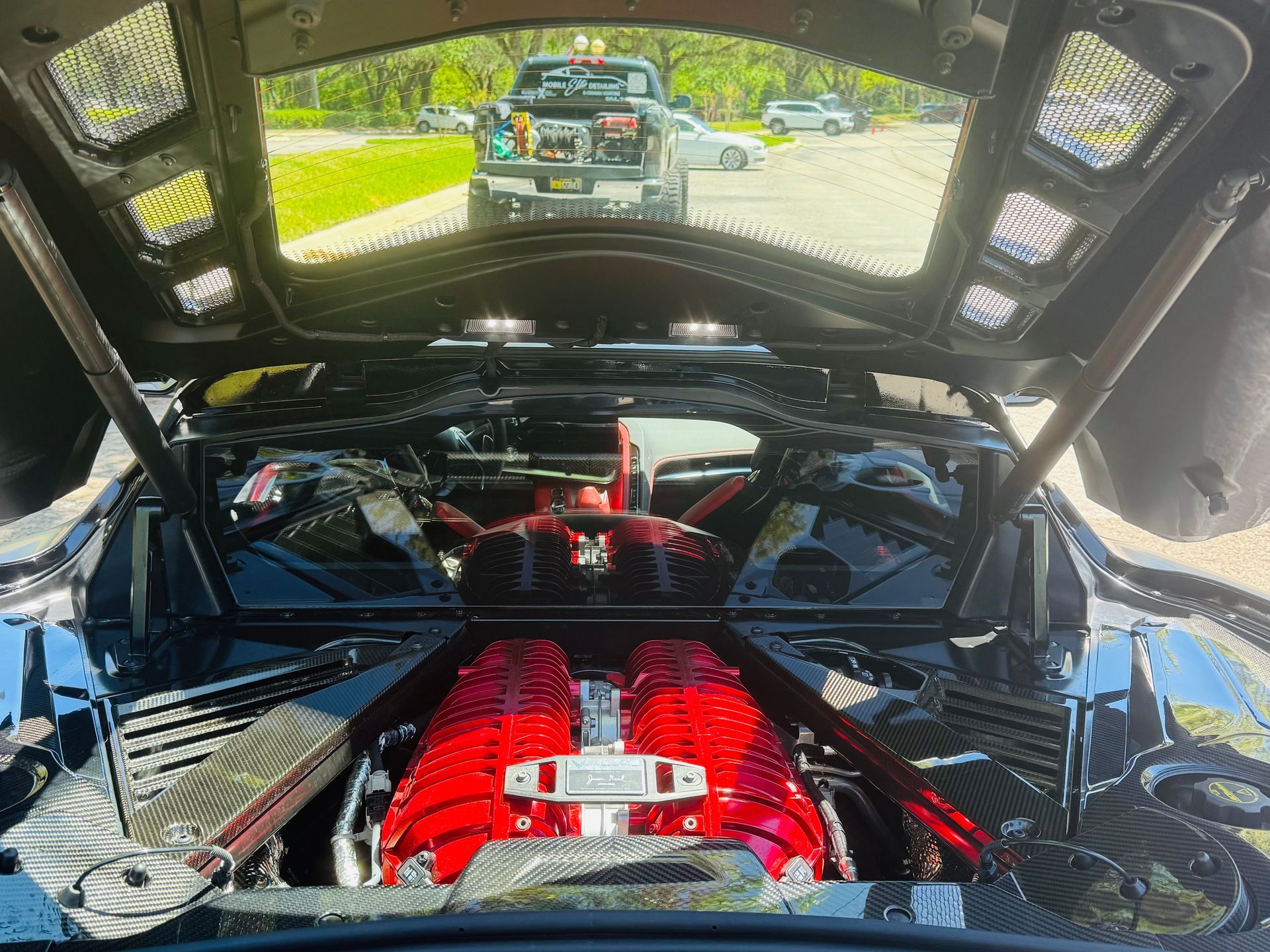 A black sports car is parked on the side of the road.