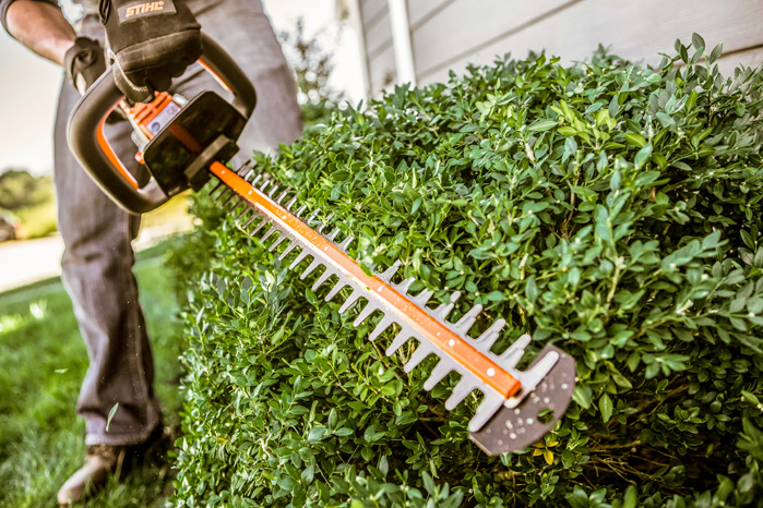 A husqvarna lawn blower is sitting in the grass