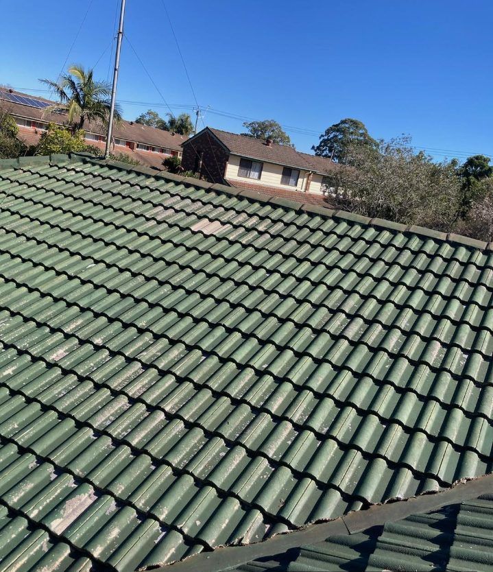 A Roof With Green Tiles is Being Restored by Roofing and Restoration — Wayne Treasure Roofing & Restoration In Nabiac, NSW
