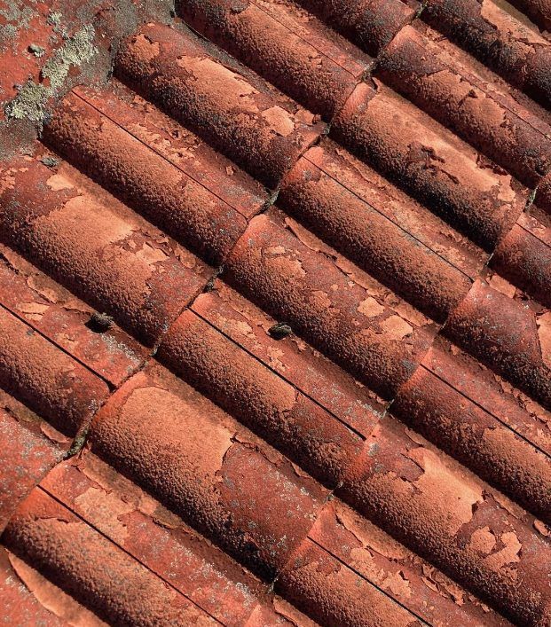 A close up of a roof made of red tiles — Wayne Treasure Roofing & Restoration In Nabiac, NSW