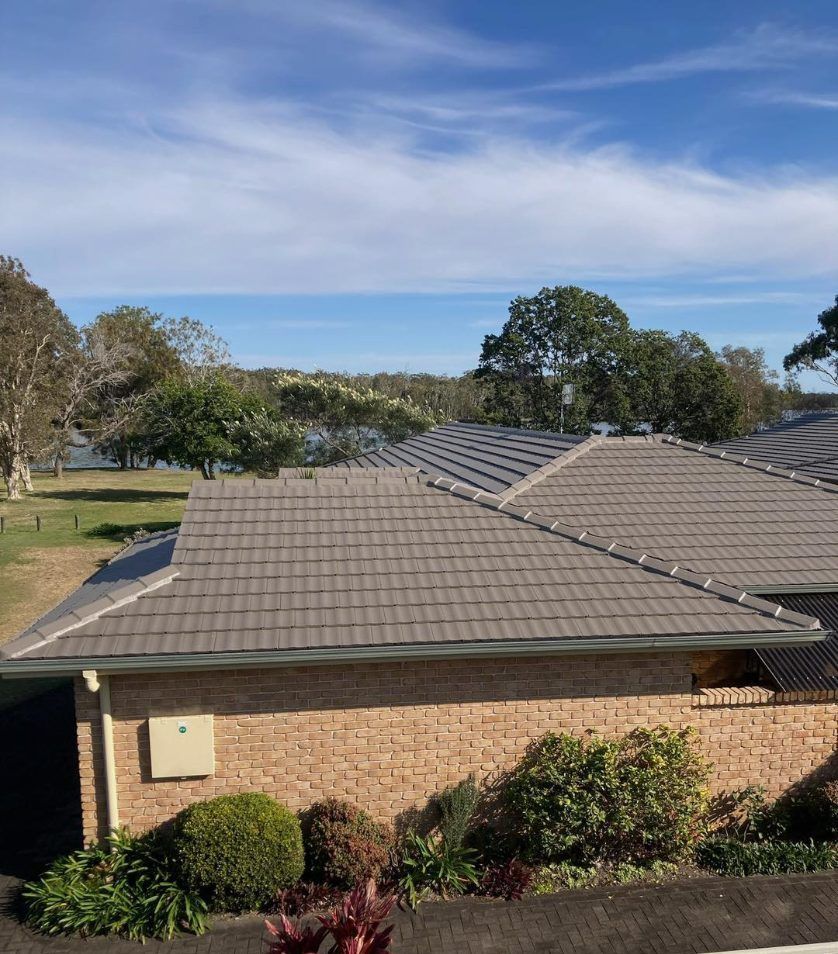 A House With a Roof That Has Been Restored by Roofing and Restoration — Wayne Treasure Roofing & Restoration In Old Bar, NSW