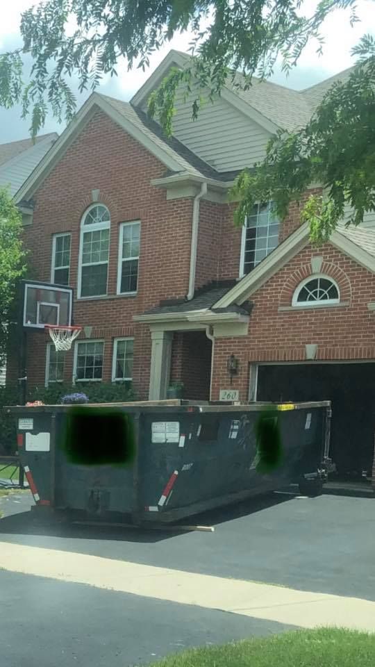 A large brick house with a basketball hoop in front of it