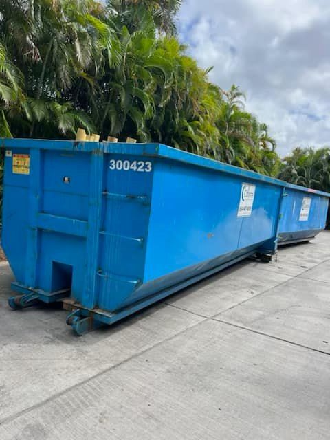 A blue dumpster with the number 300423 on it