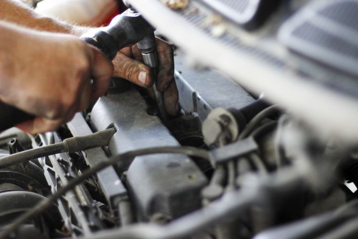 Hand of auto mechanic with a wrench