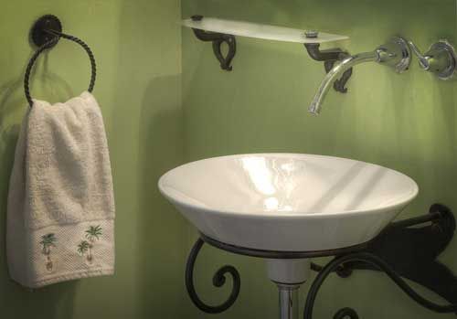 A bathroom with a sink and a towel hanging on the wall.