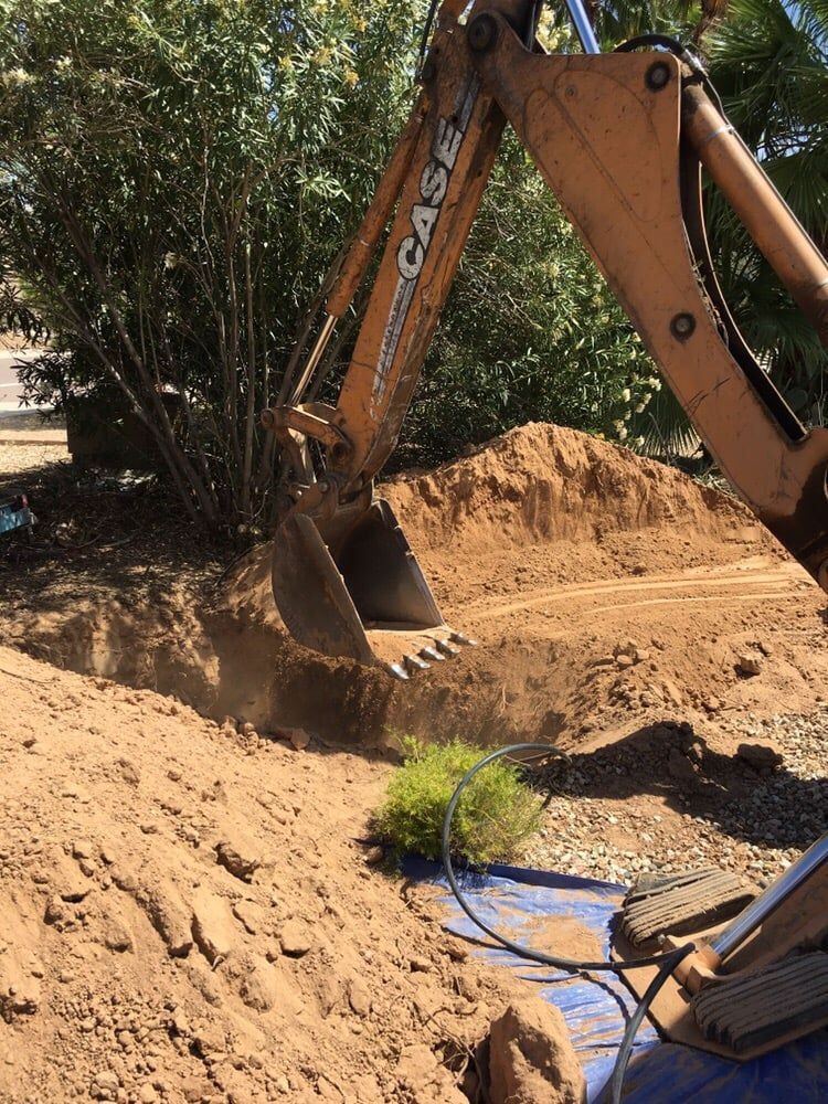 A case excavator is digging a hole in the dirt.