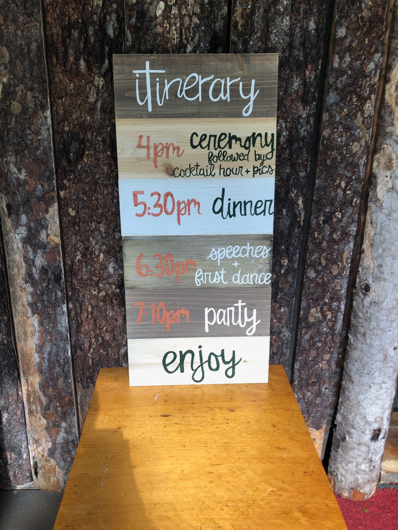 itinerary for a wedding on wooden signs