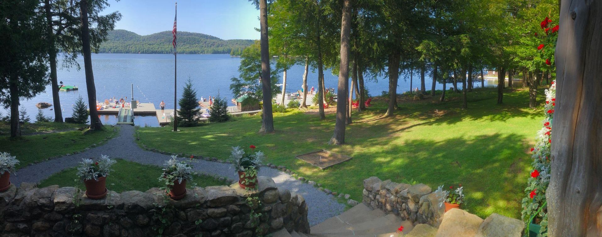 a view of a lake from a porch of a large building.