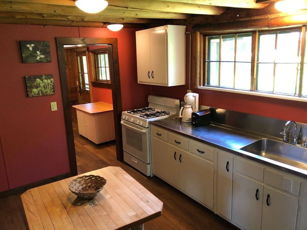 a kitchen with white cabinets and a stove and sink