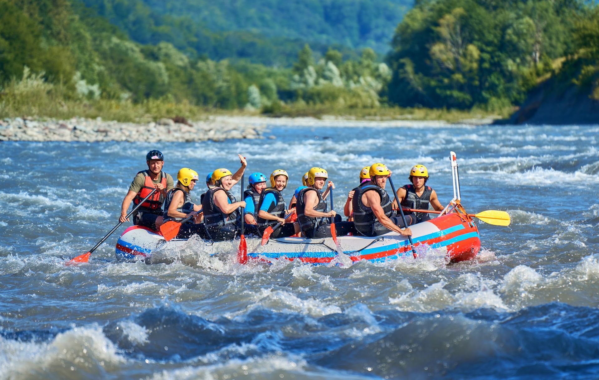 A group of people are rafting down a river in a raft.