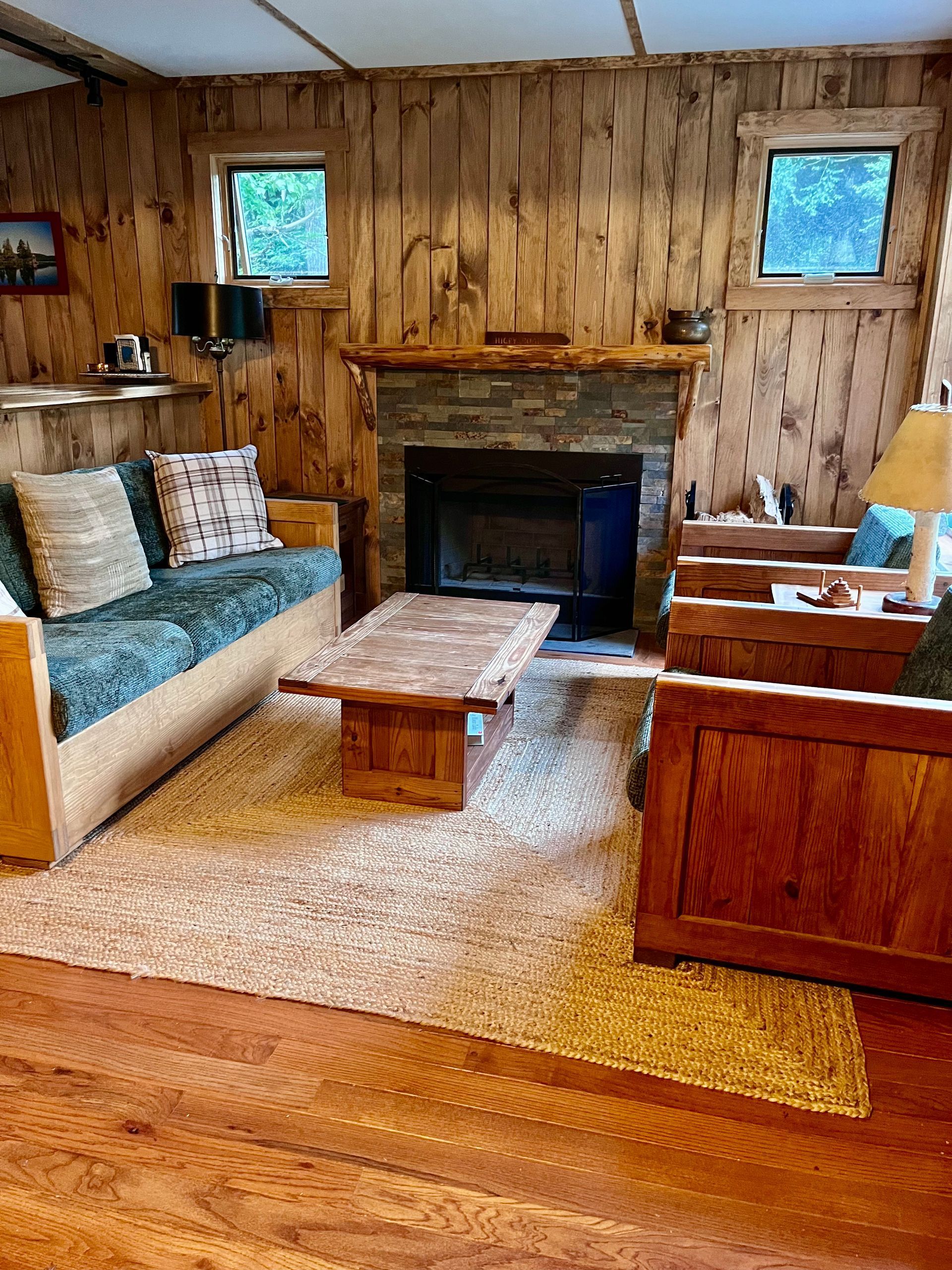 a living room with wood paneling and a large window