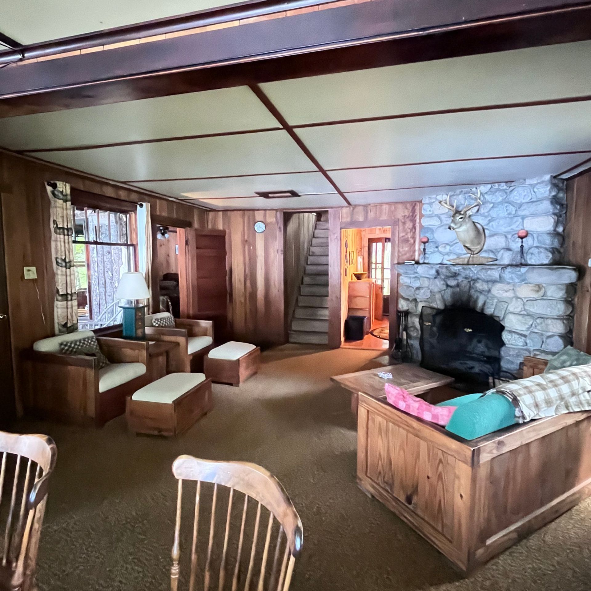 a living room with a stone fireplace and a couch