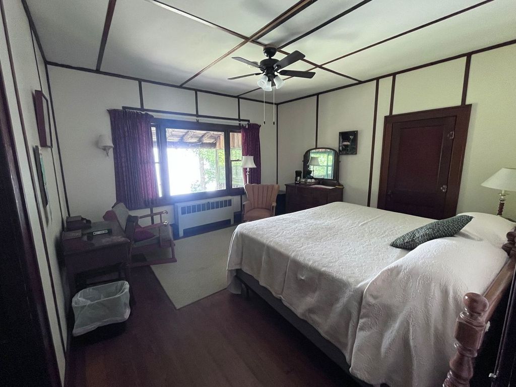 a bedroom with a king size bed and a ceiling fan .