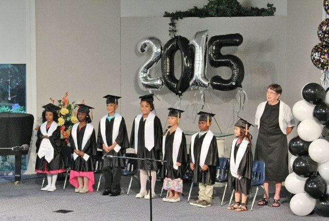 Students standing on stage at a graduation ceremony in Chesapeake, VA