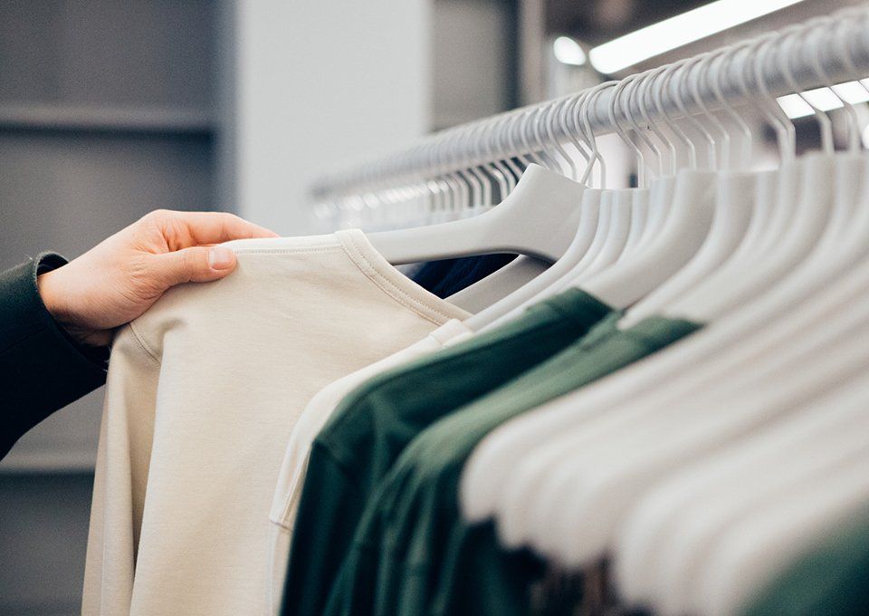 Hand Of Man Holding Shirt — Wichita, KS — Top Priority Concierge