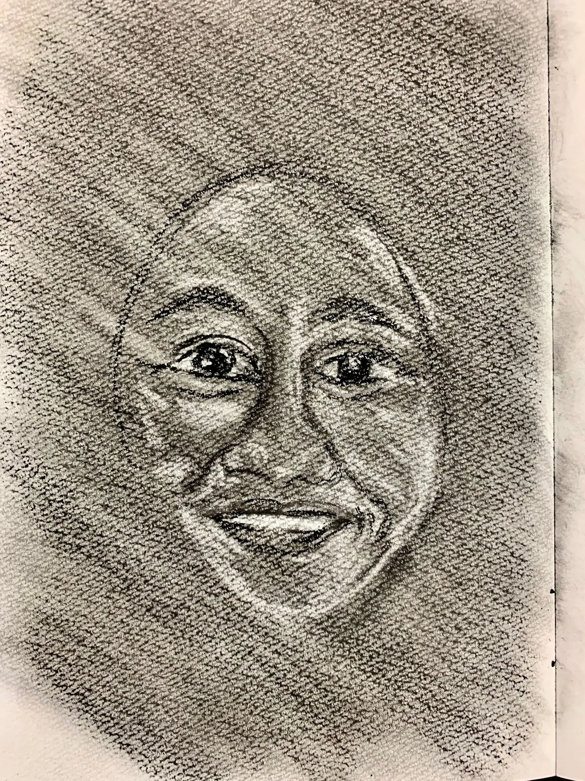Smiling face drawn in charcoal, with expressive eyes. Dark background.
