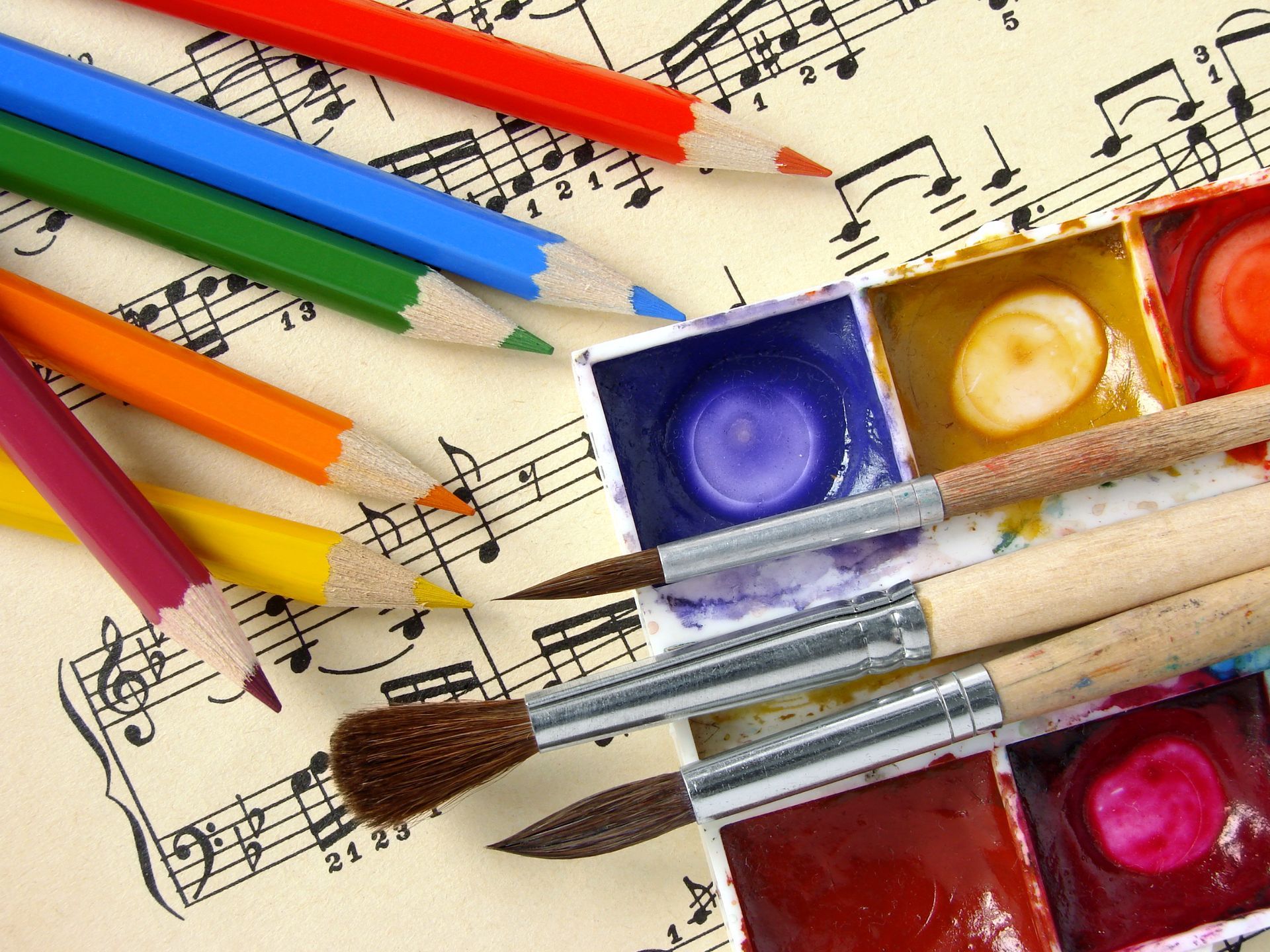 People playing violins; close-up on hands holding instruments.