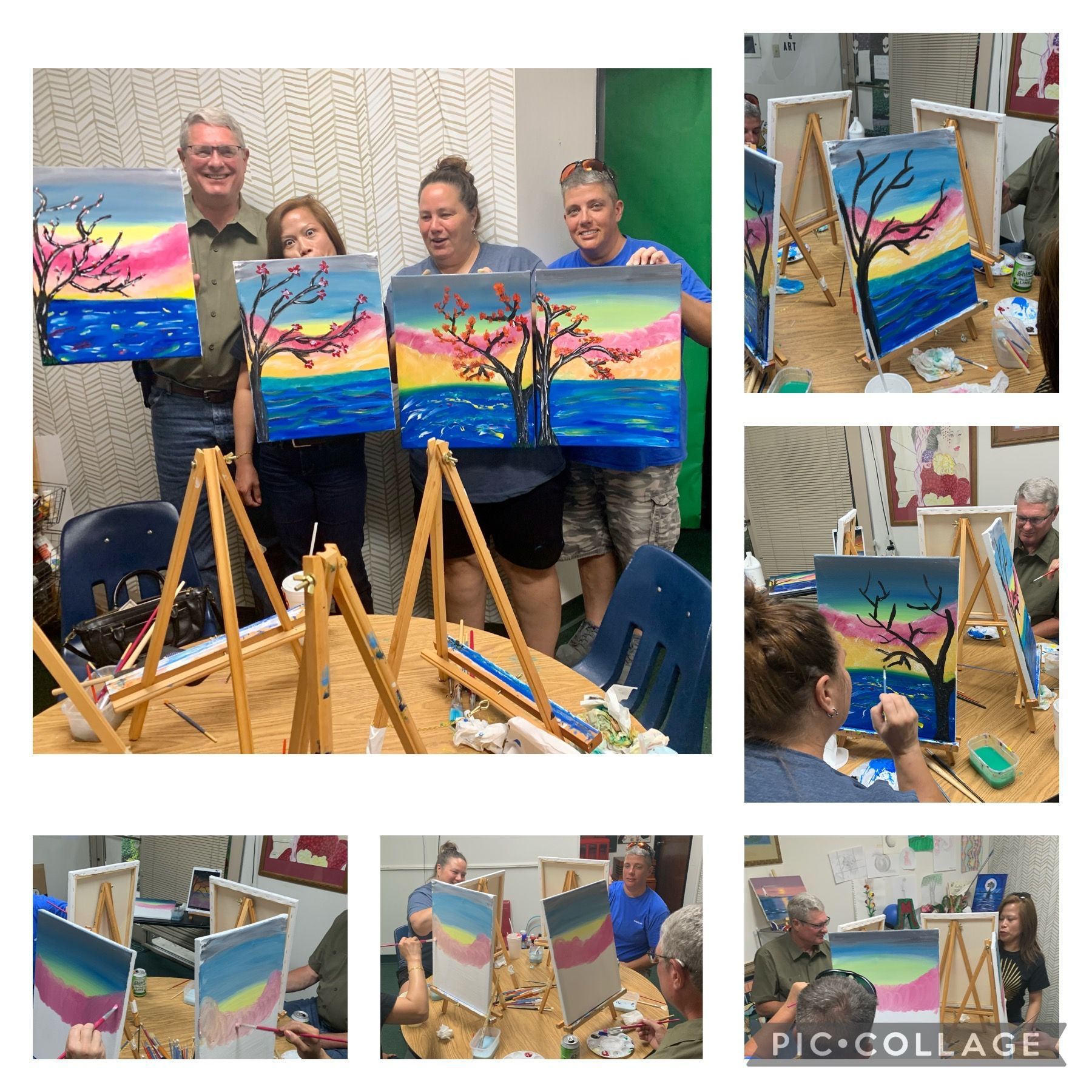 People painting colorful sunset scenes at a workshop.