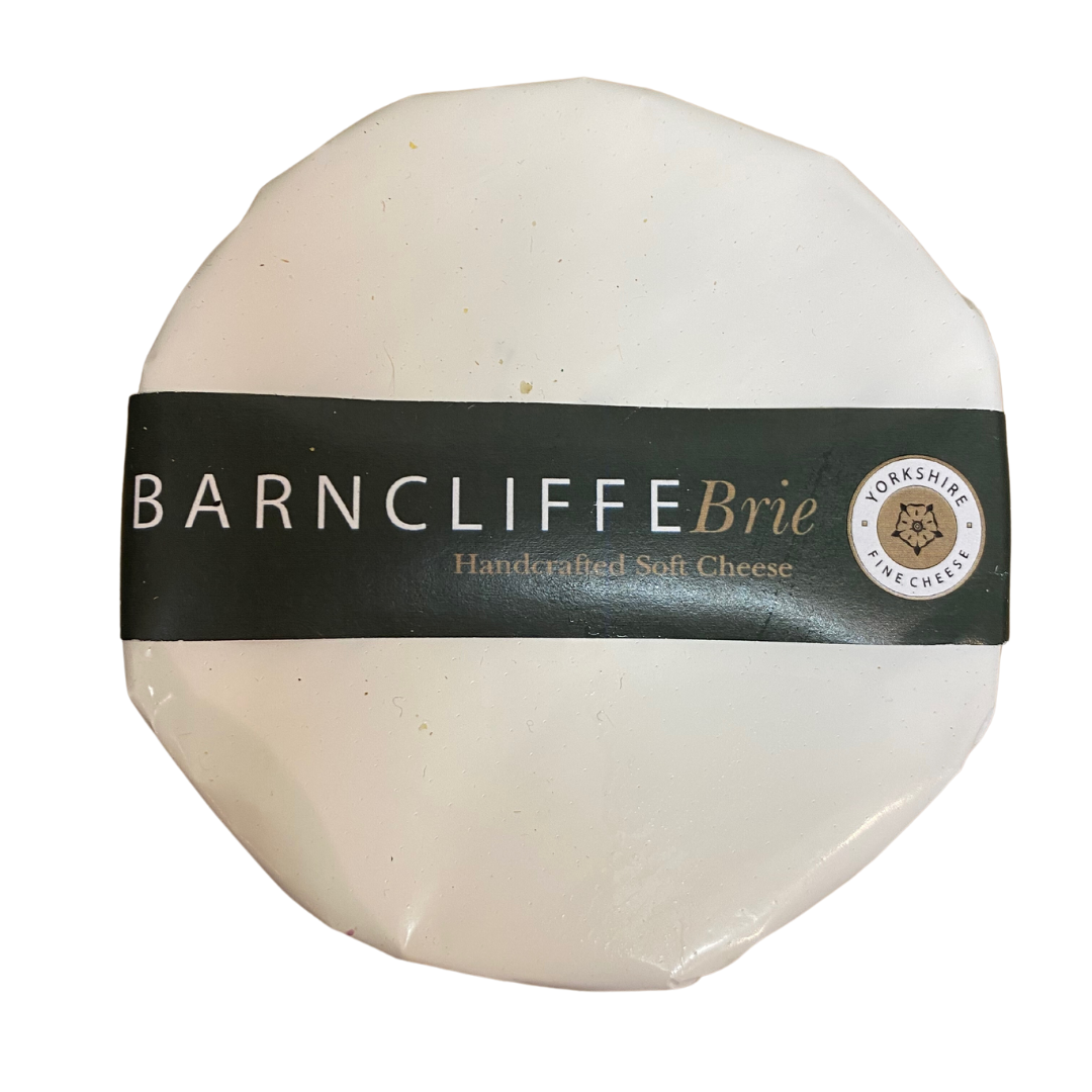 Handmade by Ruth at her West Yorkshire dairy, this soft mould-ripened cheese is created using rich local cow’s pasteurised milk from the Meuse-Rhine-Issel herd, which grazes just 5 minutes away from the dairy. The cheese develops its distinctive white coat while ripening in a temperature and humidity-controlled room with a filtered fresh air system to replicate the conditions found in original cheese cellars. With a smooth texture, rich golden center, and unique flavour, Barncliffe Brie is a must-try for anyone looking for a delicious cheese experience.