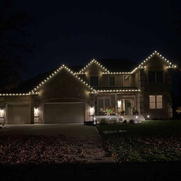Multi-color Christmas light installation on a Rogers, MN home in Fox Creek