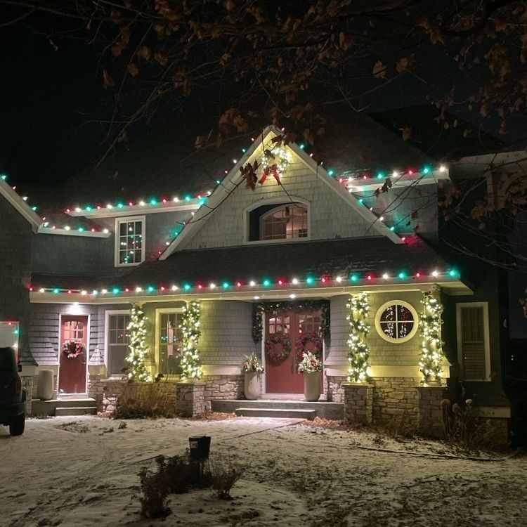 Luxury Christmas lighting outlining a lakefront estate in Wayzata, MN