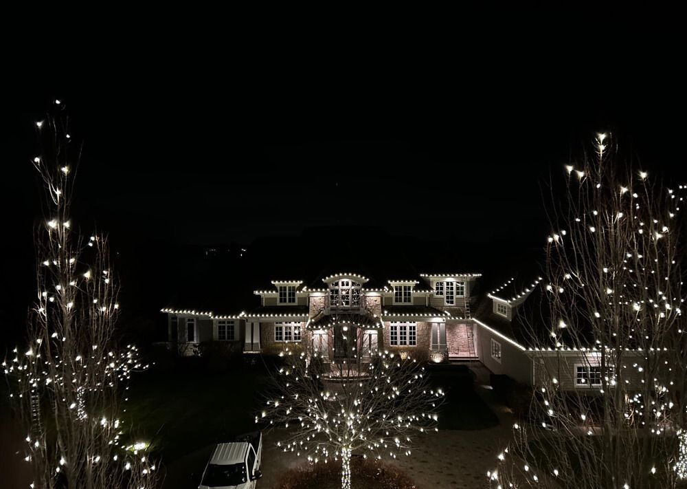 Holiday lighting wrapped around a front porch and columns in Frogtown, St Paul, MN